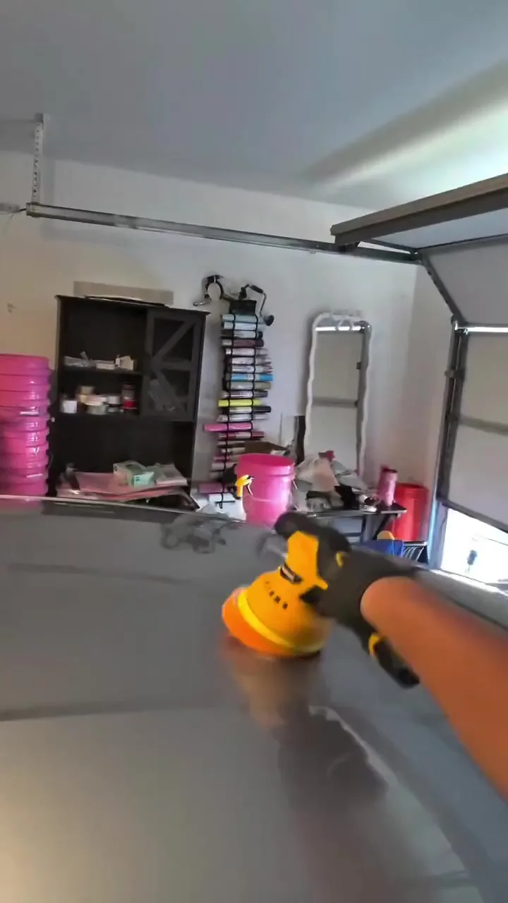 Adrian machine polishing a Mustang during a paint correction